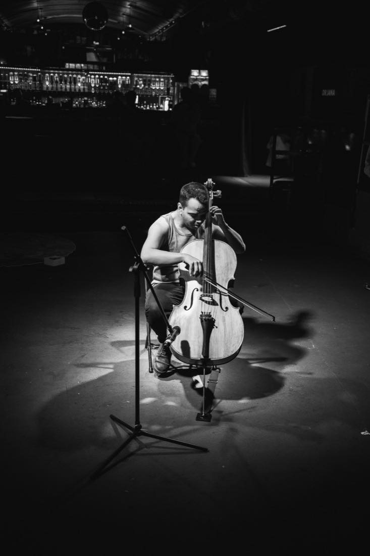A cellist, alone in the spotlight.