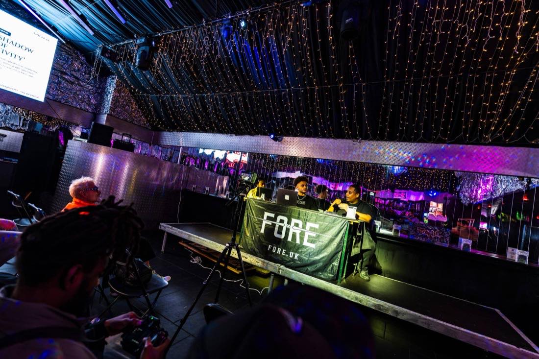 The FORE podcast desk under fairy lights, filmed on camera