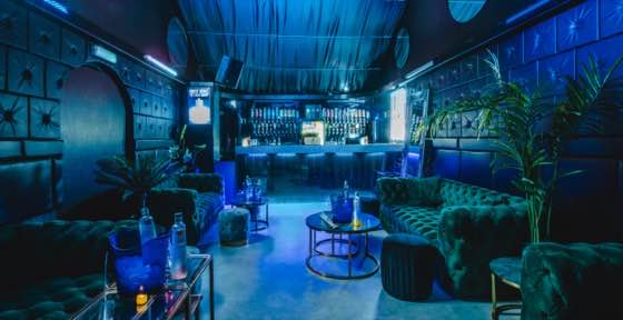 Mirror Arch Lounge — a private room with velvet seating and its own bar